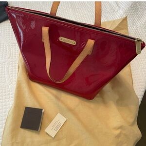 Red Louis Vuitton patent leather handbag